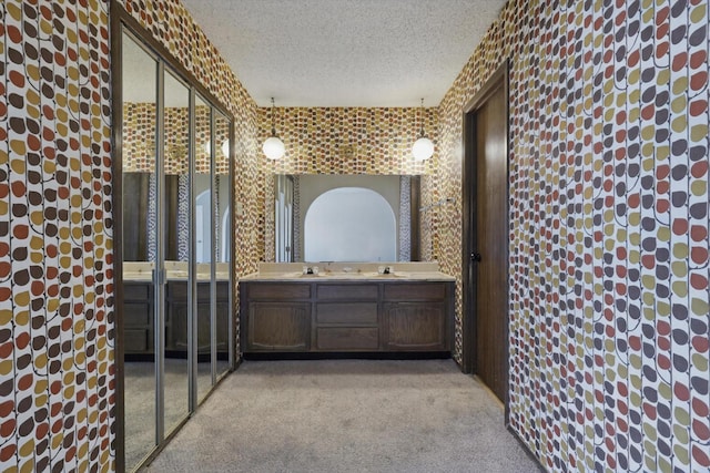 bathroom featuring a textured ceiling and vanity