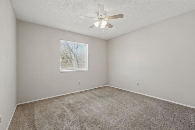 empty room with carpet, ceiling fan, a textured ceiling, and baseboards