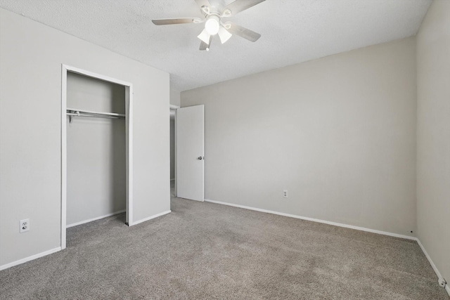 unfurnished bedroom featuring carpet, a closet, a ceiling fan, a textured ceiling, and baseboards