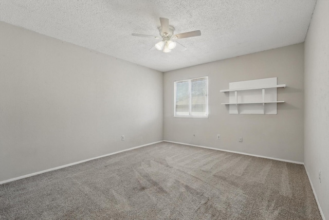 carpeted empty room with a ceiling fan, a textured ceiling, and baseboards