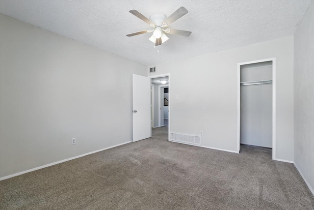 unfurnished bedroom featuring carpet, visible vents, and a textured ceiling