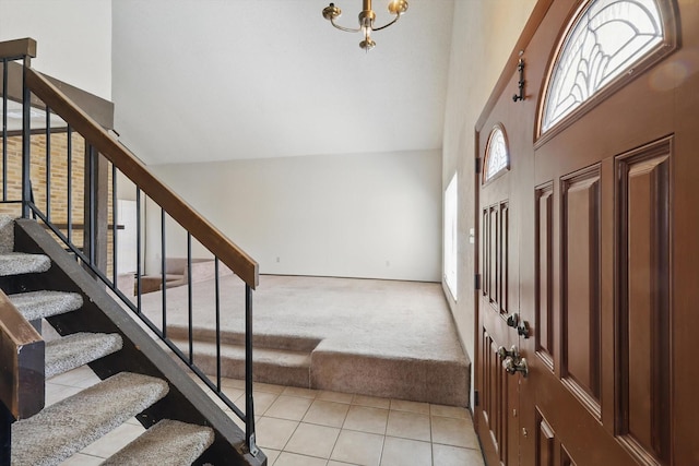 entrance foyer featuring light carpet, stairway, and light tile patterned floors