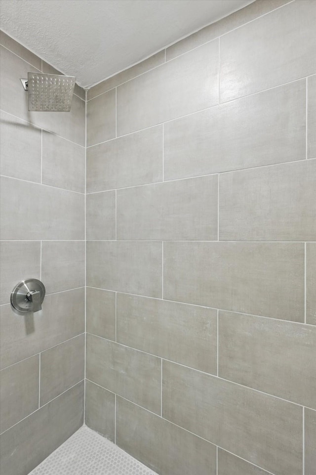 bathroom with a tile shower