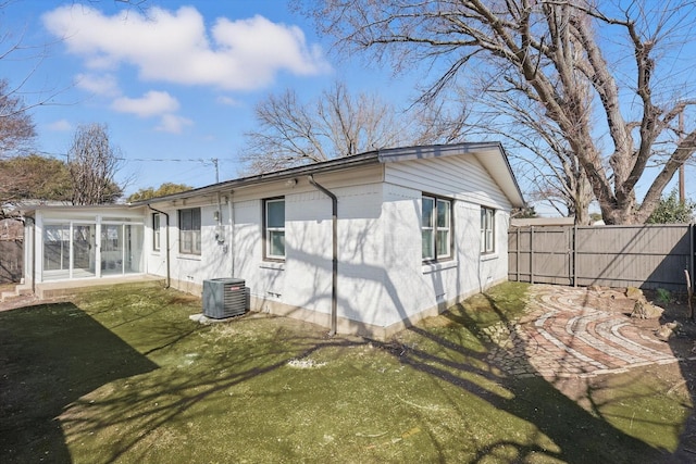 back of house featuring a sunroom, central air condition unit, and fence