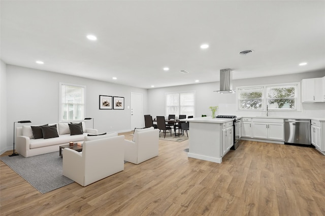 living area featuring visible vents, recessed lighting, and light wood finished floors