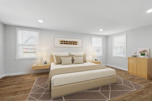 bedroom with baseboards, wood finished floors, and recessed lighting