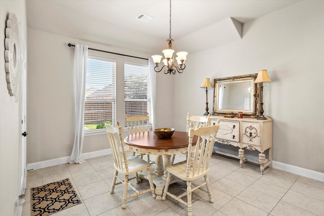 dining room with light tile patterned floors, visible vents, baseboards, and a chandelier