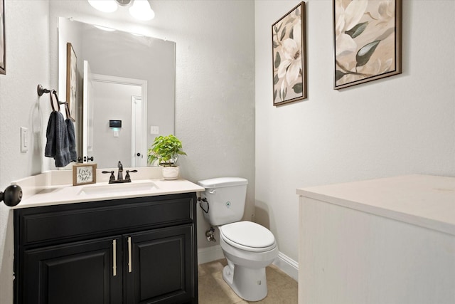 half bath with vanity, toilet, and baseboards