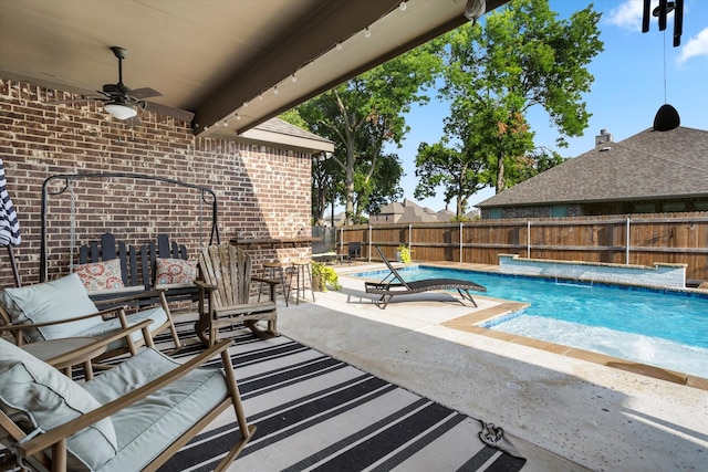 view of pool featuring a ceiling fan, a patio area, a fenced backyard, and a fenced in pool