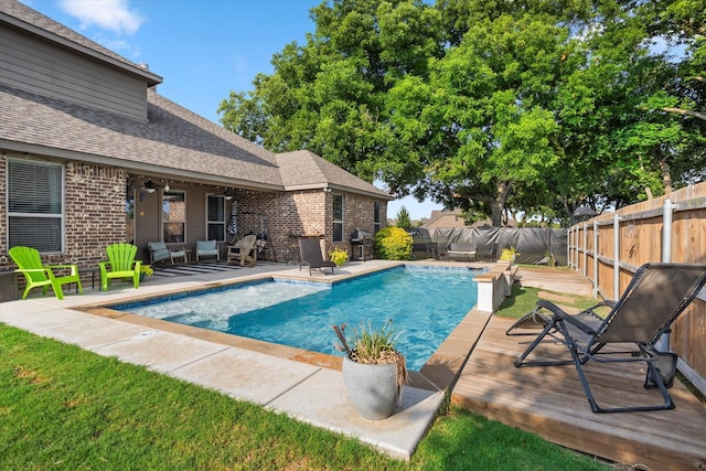 view of swimming pool featuring a fenced in pool, a fenced backyard, and a patio