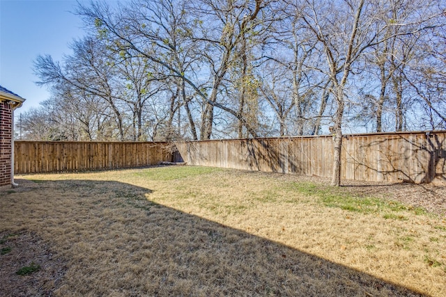 view of yard with a fenced backyard