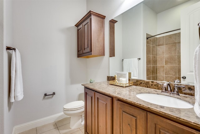 bathroom with baseboards, toilet, tile patterned flooring, walk in shower, and vanity