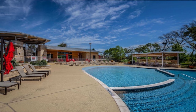 pool featuring fence and a patio