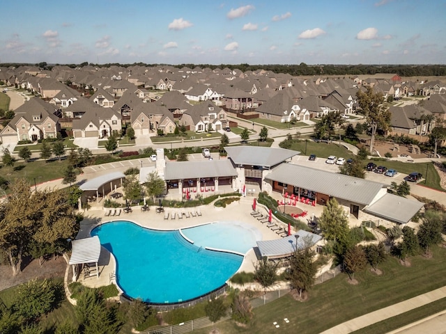 community pool featuring a patio area and a residential view