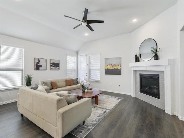 living room with a fireplace, lofted ceiling, recessed lighting, dark wood-type flooring, and baseboards