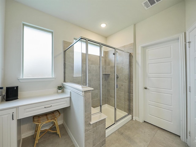 full bathroom with a stall shower, tile patterned flooring, and visible vents