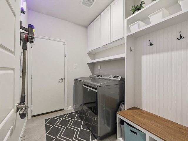 washroom with cabinet space, visible vents, and independent washer and dryer