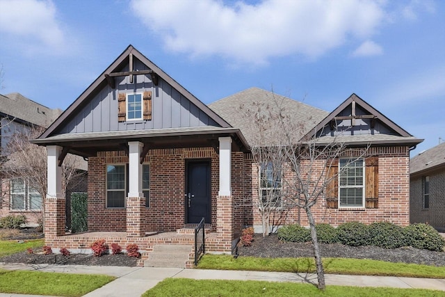 view of front of house featuring board and batten siding and brick siding