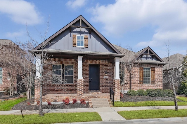 view of front of property with board and batten siding and brick siding