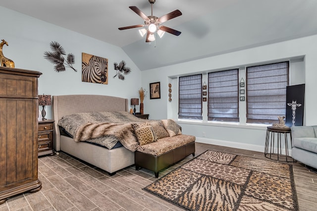 bedroom featuring vaulted ceiling, wood finish floors, a ceiling fan, and baseboards