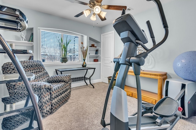 exercise area featuring ceiling fan, baseboards, and carpet flooring