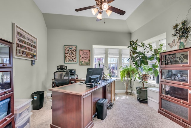 home office with light carpet, vaulted ceiling, a ceiling fan, and baseboards