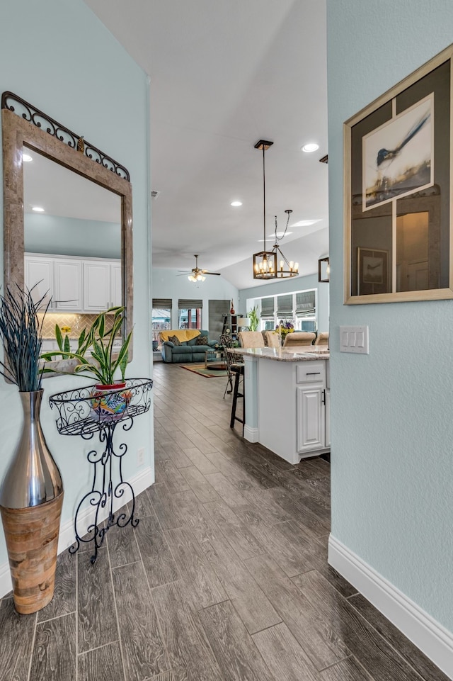 hall featuring wood finish floors, recessed lighting, and baseboards