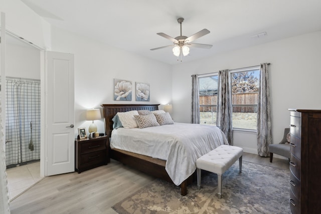 bedroom featuring a ceiling fan, visible vents, and light wood-style flooring