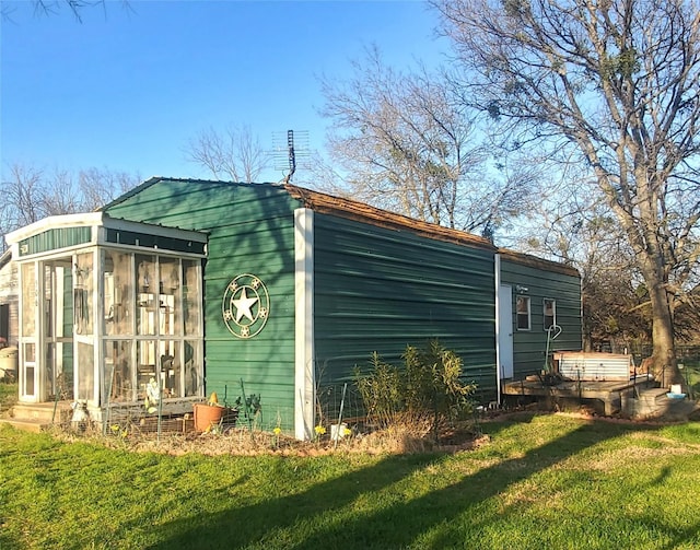 view of outbuilding with a sunroom