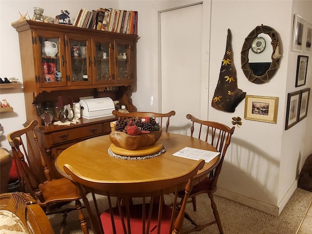 dining room featuring baseboards and light speckled floor