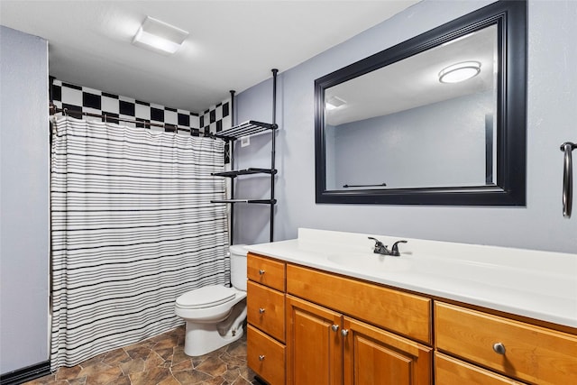 full bath featuring toilet, stone finish floor, vanity, and a shower with curtain