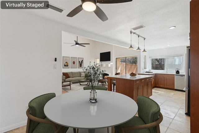 dining area featuring lofted ceiling, visible vents, and light tile patterned flooring