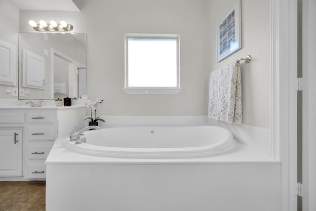 full bathroom with vanity, a bath, and tile patterned floors