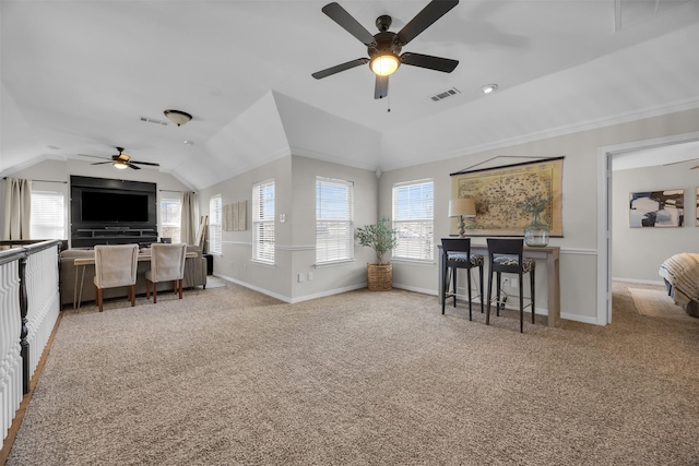 living area featuring baseboards, visible vents, vaulted ceiling, and carpet flooring