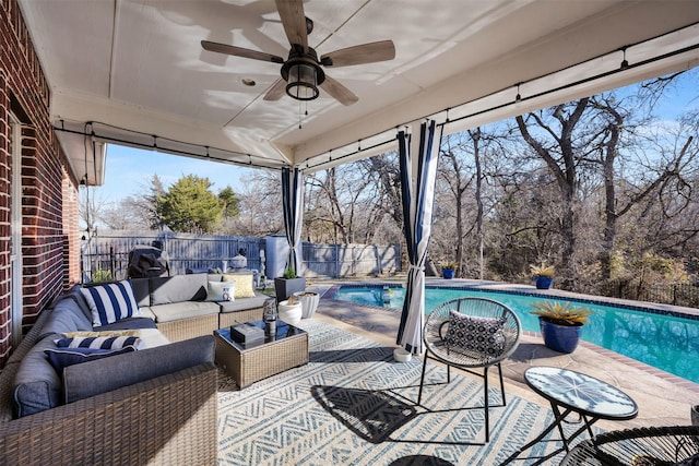 view of patio featuring ceiling fan, a fenced backyard, an outdoor living space, and a fenced in pool