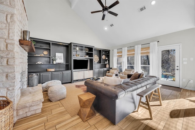 living area featuring high vaulted ceiling, wood finish floors, and visible vents