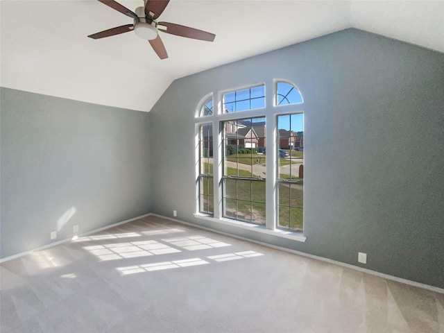 additional living space with carpet floors, a healthy amount of sunlight, and vaulted ceiling