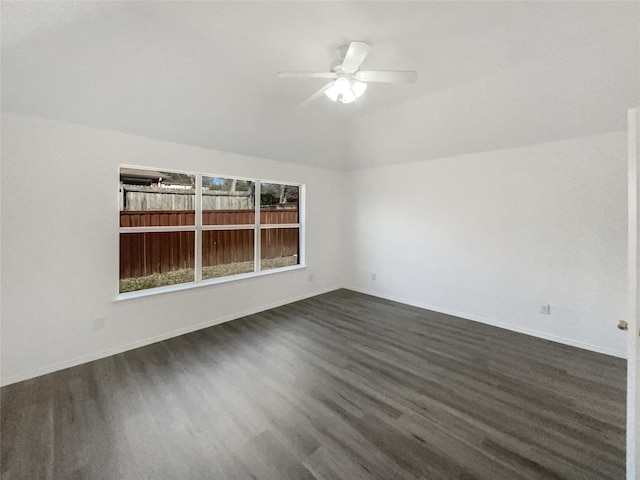 unfurnished room with dark wood-style floors, lofted ceiling, ceiling fan, and baseboards