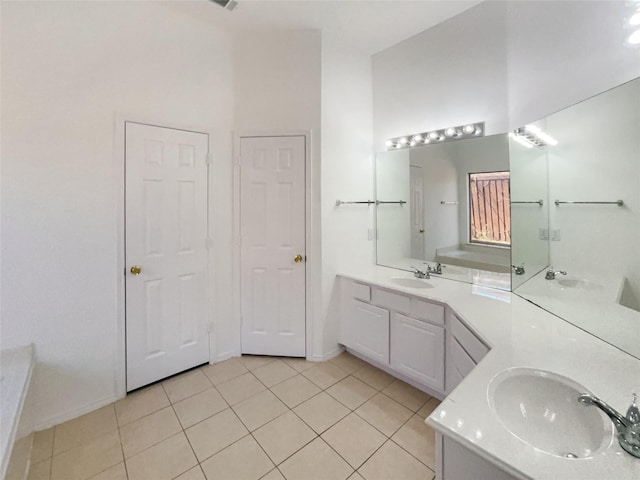 bathroom featuring a towering ceiling, tile patterned flooring, two vanities, and a sink