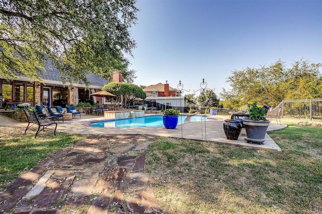 outdoor pool featuring a yard, a fenced backyard, and a patio