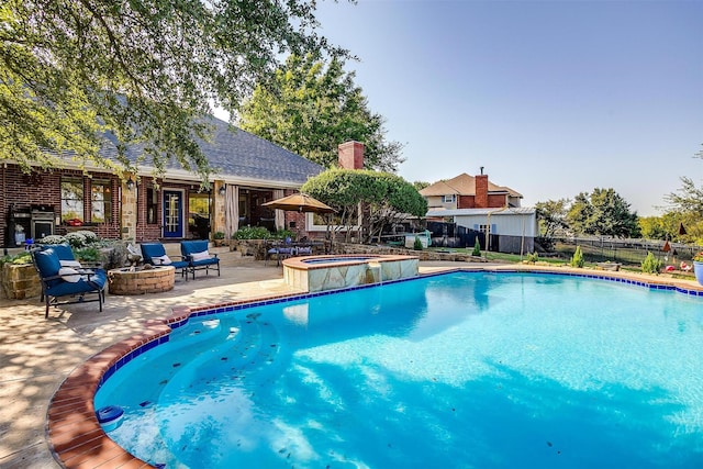 view of pool featuring a fenced in pool, a patio, a fire pit, and an in ground hot tub