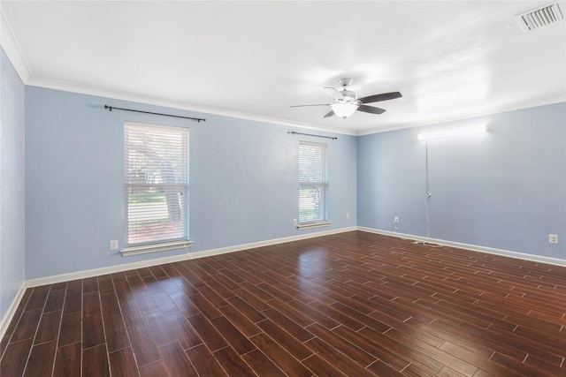 empty room with baseboards, visible vents, ceiling fan, wood finished floors, and crown molding