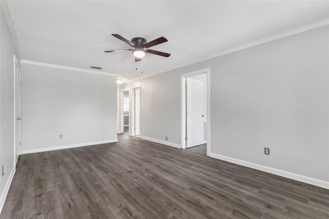 empty room with ornamental molding, dark wood-type flooring, visible vents, and baseboards