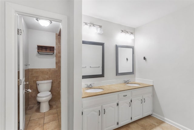 full bath featuring tile walls, a sink, and tile patterned floors