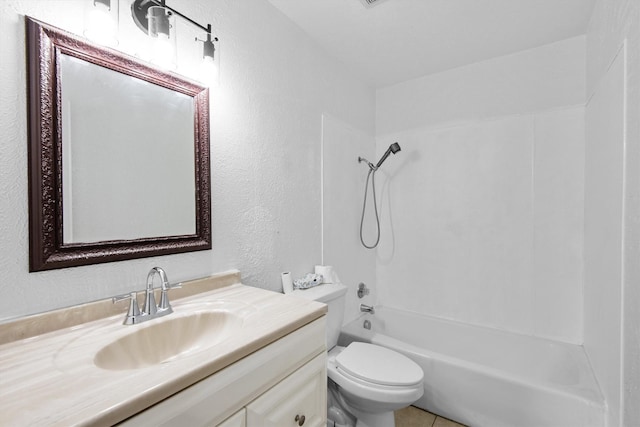 bathroom featuring tub / shower combination, a textured wall, vanity, and toilet