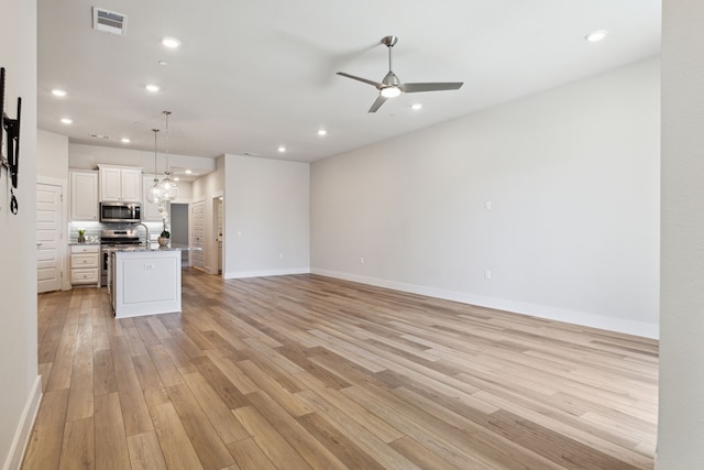 3830 Dalea Dr, Prosper, TX 75078 - unfurnished living room featuring ceiling fan, recessed lighting, visible vents, baseboards, and light wood-style floors