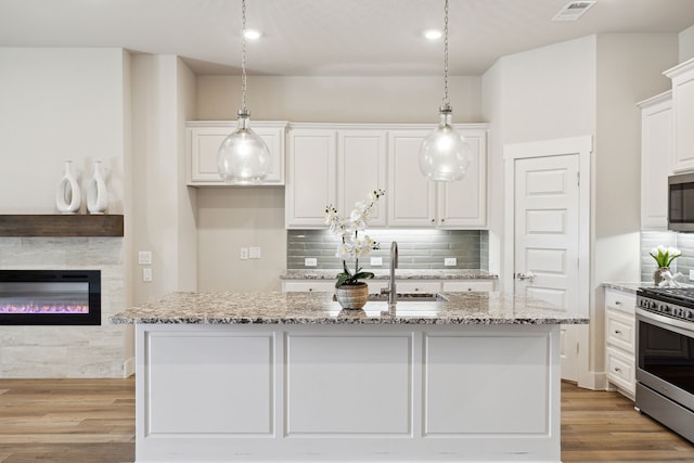 3830 Dalea Dr, Prosper, TX 75078 - kitchen featuring a sink, visible vents, white cabinetry, appliances with stainless steel finishes, and an island with sink