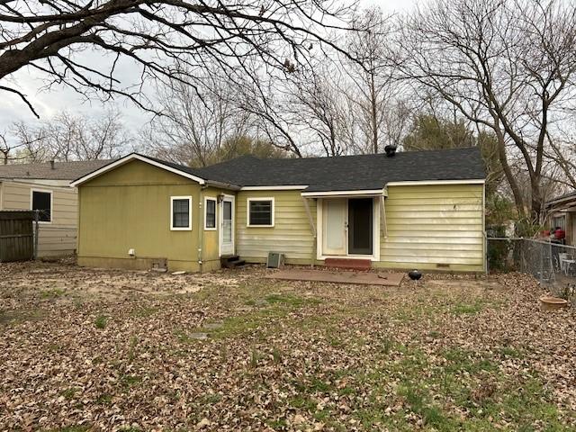 view of front of house with crawl space and fence