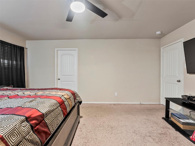 carpeted bedroom featuring ceiling fan and baseboards