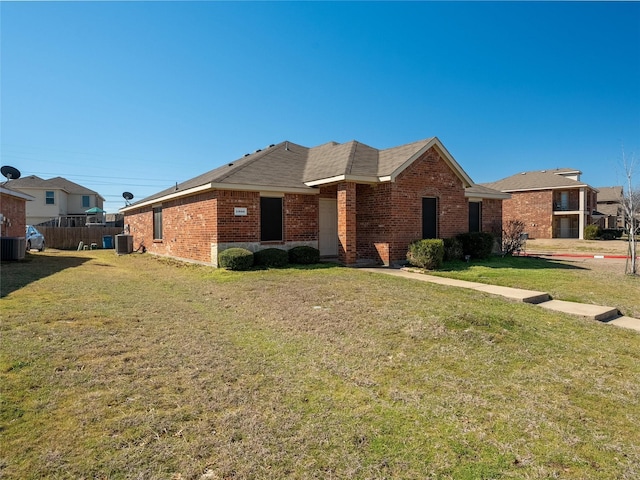 single story home featuring cooling unit, brick siding, and a front lawn